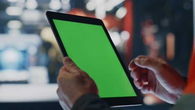 Engineer hands working green screen tablet computer in factory workshop close up