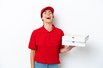 Pizza delivery caucasian woman with work uniform picking up pizza boxes isolated on white background laughing