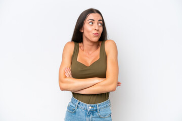 Young caucasian woman isolated on white background making doubts gesture while lifting the shoulders