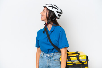 Young caucasian woman with thermal backpack isolated on white background laughing in lateral position