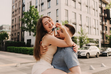 Focus on keys, held by excited young spouses homeowners. Happy married family couple celebrating moving in new house home , demonstrating keys, standing in apartment, real estate mortgage concept