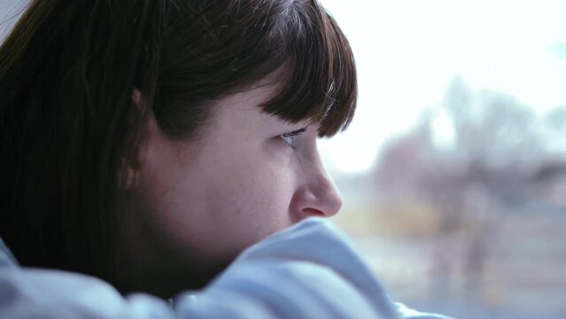 Reflecting on Painful Memories: Woman Contemplating by the Window