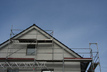 Residential building behind scaffolding - energy-efficient renovation