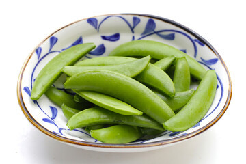 Fresh young green peas on white background.