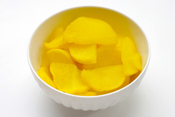Sweet and tart slices of yellow pickled daikon, known as takuan in Japan and danmuji in Korea.