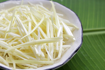 White garlic chives on banana leaf