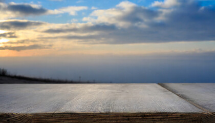 empty wooden table against the backdrop of a blurred blue sky sunrise background high quality photo