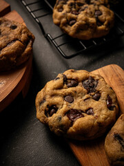 Cookies are arranged messily on a wooden placemat, isolated with a wooden table background.