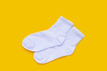 White socks on yellow background.