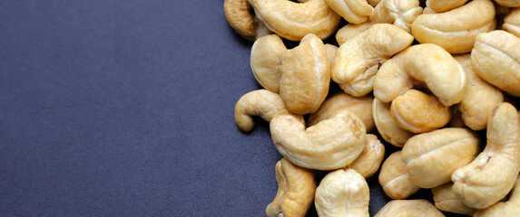 Cashew nuts on dark background.
