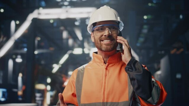 Happy plant technician calling telling about successful production work close up