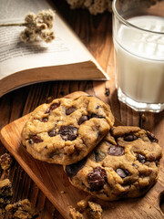 Cookies are arranged messily on a wooden placemat, isolated with a wooden table background.