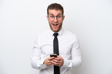 Young business caucasian man isolated on white background surprised and sending a message