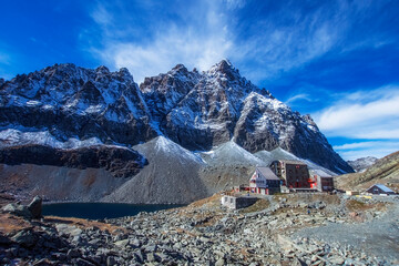 Alpine refuge "Quintino Sella" (2650 meters above sea level) stands near the "Lago Grande di Viso" with the snow-capped Monviso (Mount Viso or Monte Viso, 3841 meters above sea level), Piedmont, Italy