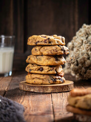 Cookies are stacked neatly on a wooden placemat, isolated with a wooden table background.