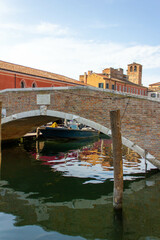 Fototapeta na wymiar Bridge cross water canal in historical center of Chioggia town, Veneto, Italy, Europe