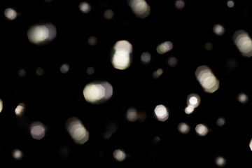 festive New Year's bokeh of warm yellow color, blurred on a dark background