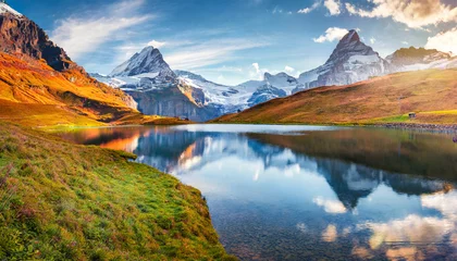 Zelfklevend Fotobehang panoramic morning view of bachalp lake bachalpsee switzerland majestic autumn scene of swiss alps grindelwald bernese oberland europe beauty of nature concept background © Nichole