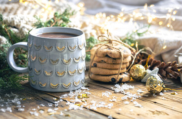 Winter composition with a cup of cocoa, cookies and decorative details.
