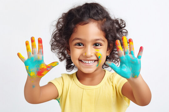 Indian child showing hands full of colors
