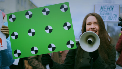 Girl with megaphone scream. Female feminist demonstration. Loudspeaker shouting. Gender rights...