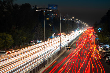 Blurred car traffic light at night city. Traffic jam in evening rush hour.