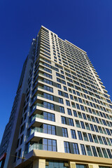 Fototapeta na wymiar Modern skyscraper against the blue sky during the daytime.