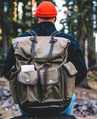 hipster guy resting during hiking tour for feeling adventure in nature environment