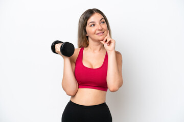 Young sport Rumanian woman making weightlifting isolated on white background thinking an idea while looking up