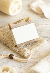 Beige handmade soap bar with blank label close up, packaging mockup