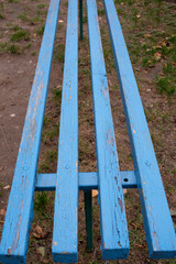 Fototapeta premium Blue city street bench made of individual boards,