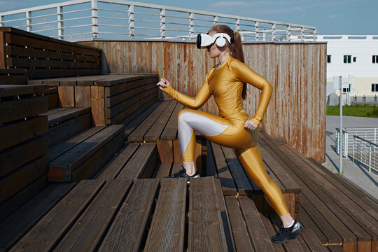 Active woman exercising with virtual reality simulator on steps