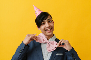 Smiling young man wearing bow tie on birthday