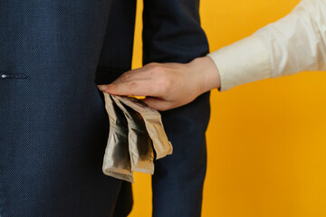 Woman putting condom packets in man's pocket