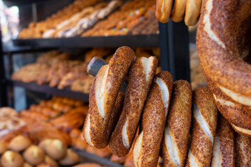 Traditional Turkish simit. Stacked turkish pastries as background. Turkish street foods