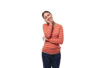 well-groomed young adult woman with black hair dressed in an orange sweater smiling at the camera on a white background