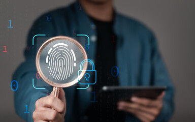 cybersecurity concept, businessman using magnifying glass focus to fingerprint core and biometric...