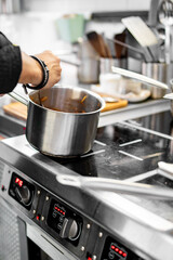 Chef cook hand cooking food at the restaurant kitchen