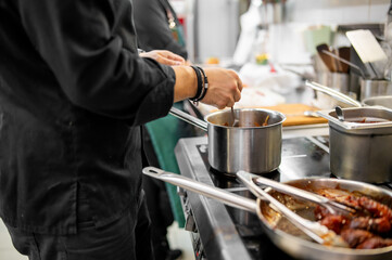 Chef cook hand cooking food at the restaurant kitchen