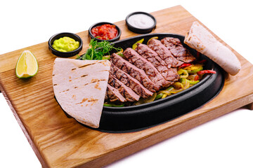 sliced fried meat with grilled vegetables and pita bread