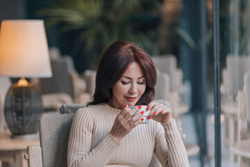 Woman looking at her coffee, pensive and nostalgic.