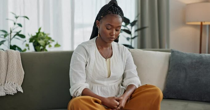 Stress, anxiety and black woman on sofa, thinking and worry with mental health in apartment living room. Sad, doubt and girl sitting on couch with fear, depression and debt trauma or mistake in home.
