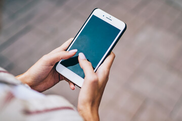 Woman's fingers chatting in social networks on mobile phone