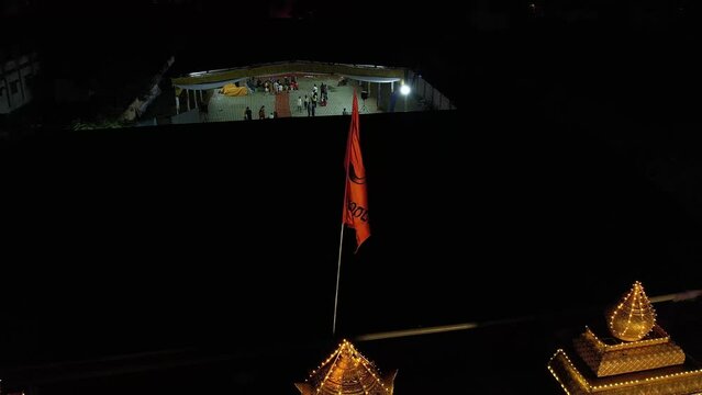 A drone shot of a Hindu saffron flag fluttering on top of a stage during event