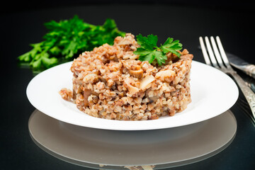 cooked buckwheat boiled with mushroom filling in a plate