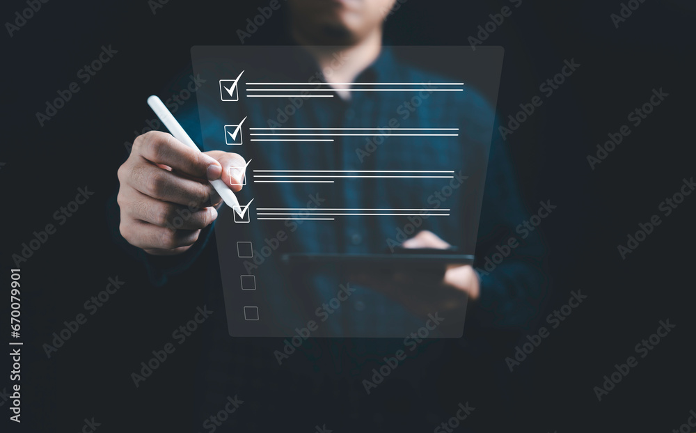 Poster Businessman using electronic pen to tick correct sign mark in online document checklist for quality control assurance of ISO concept.