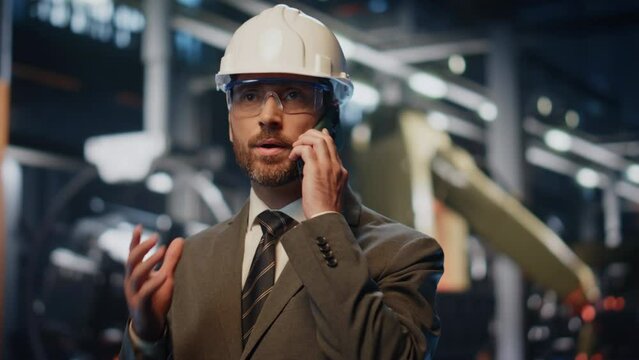 Confident plant boss calling partners at manufacturing workshop close up. 