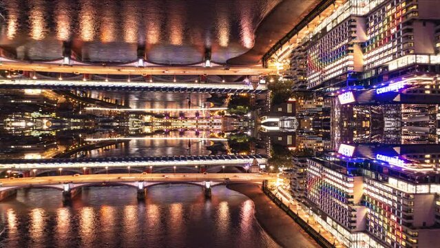 Bridges over river and buildings on waterfront in night city. Hyperlapse shot of nightlife. Abstract computer effect digital composed footage