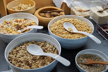 Ceramic bowls full of organic barley cereal whole grain, nuts, oats and seeds