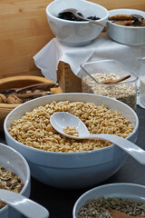 Ceramic bowls full of organic barley cereal whole grain, nuts, oats and seeds